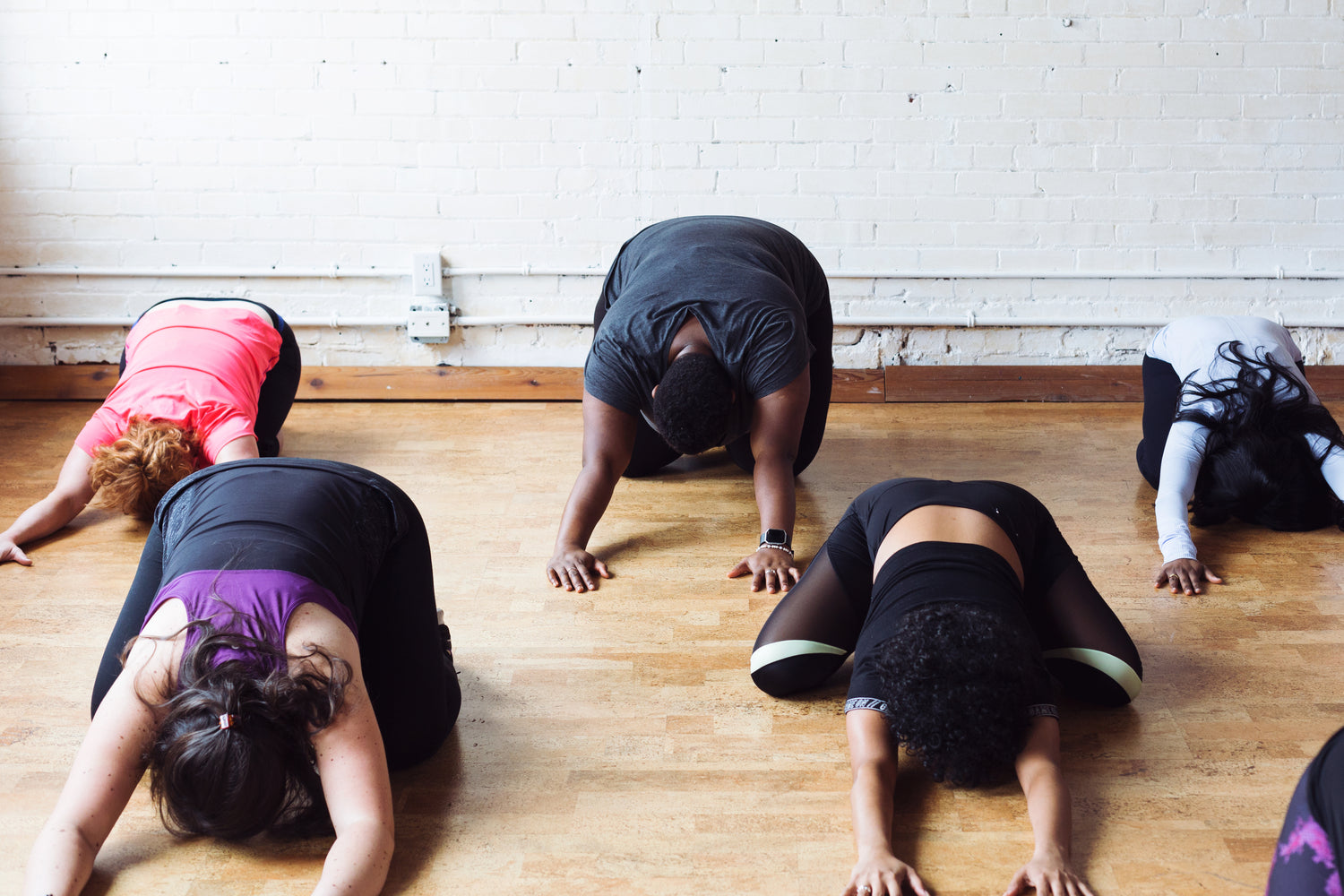 Ladies stretching after they applied CBD Wellness topical liniment spray